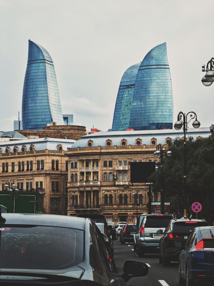 A vibrant cityscape of Baku with the famous Flame Towers and busy streets.